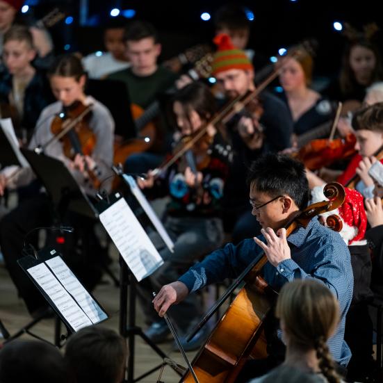 Et orkester med strygere og nissehuer på hovederne. 